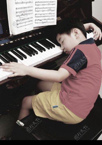 疲劳的儿童学习钢琴图片