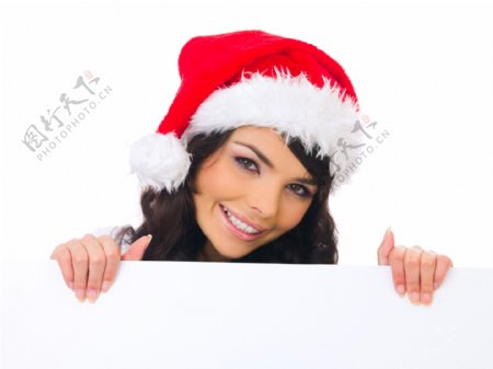 带着圣诞帽拿着广告牌的女人图片