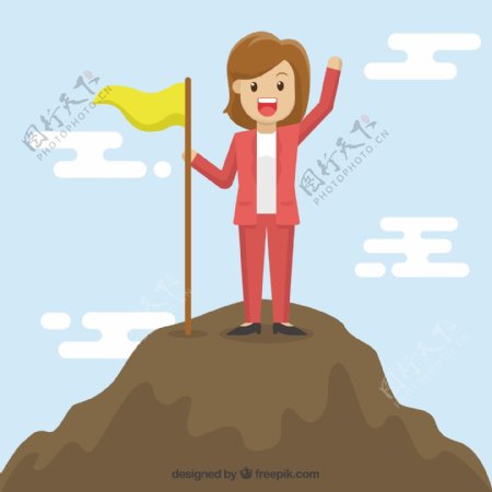 女人拿着黄色旗帜登上山顶