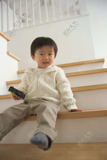 坐在楼梯间的小男孩图片