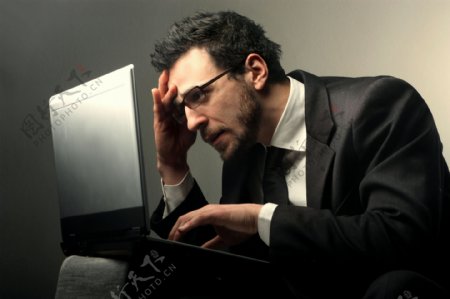 面对电脑烦恼的商务男人图片