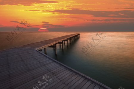 夕阳下的海边木桥图片