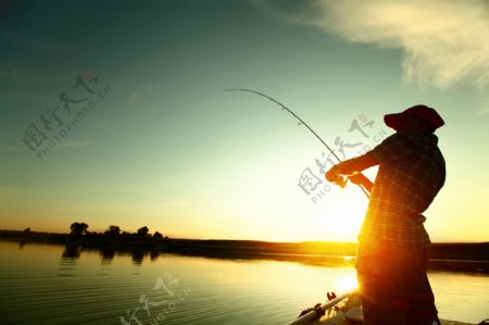 站在湖水边钓鱼的男士图片