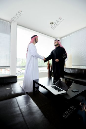 办公室里两个握手的阿拉伯男人图片