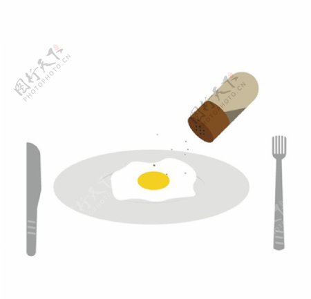 盘子上的鸡蛋撒调料胡椒罐图片